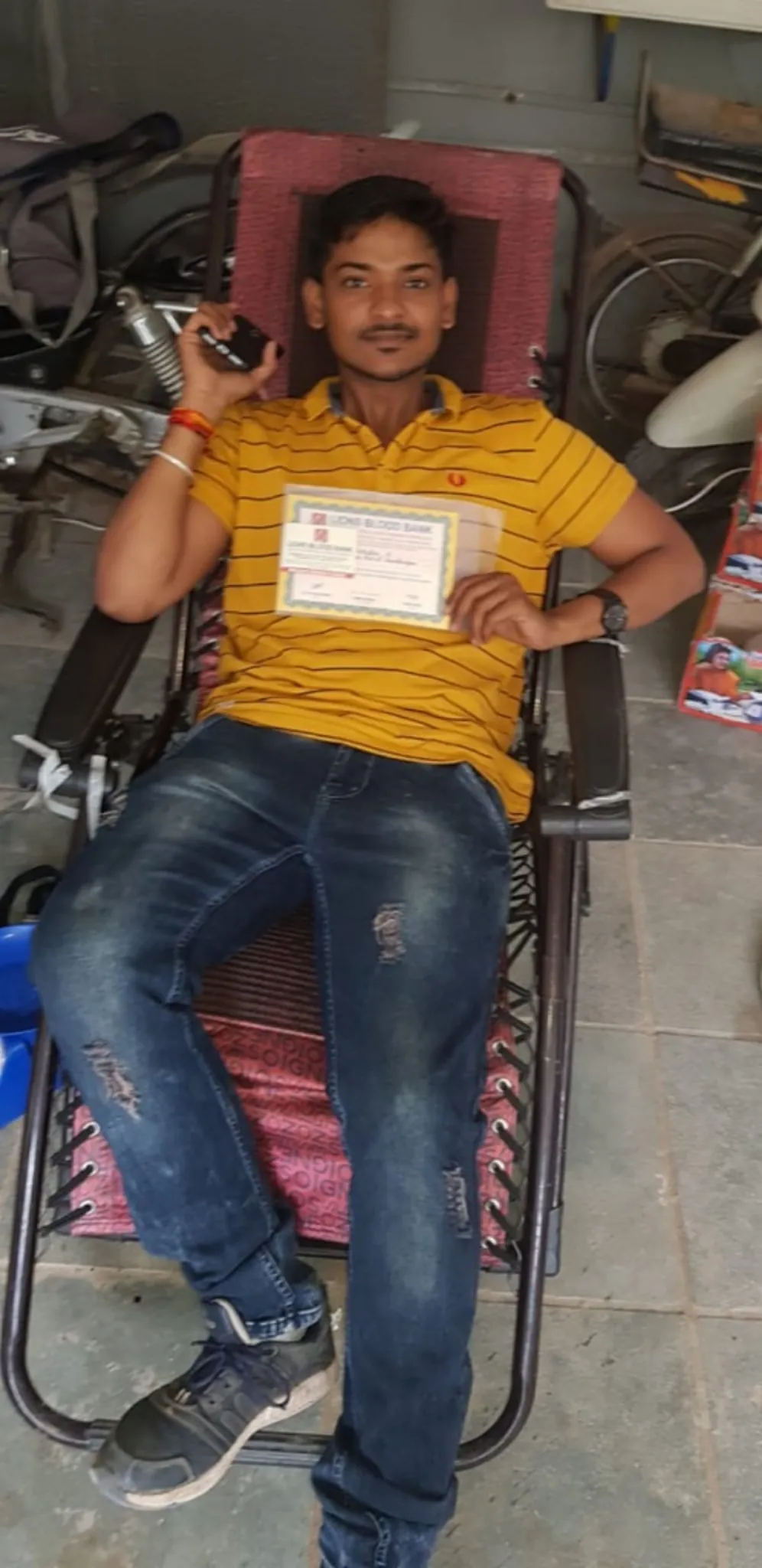 A blood donor with his certificate at a donation drive
